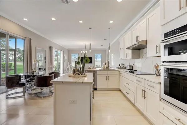 a kitchen with stainless steel appliances kitchen island granite countertop a sink and cabinets