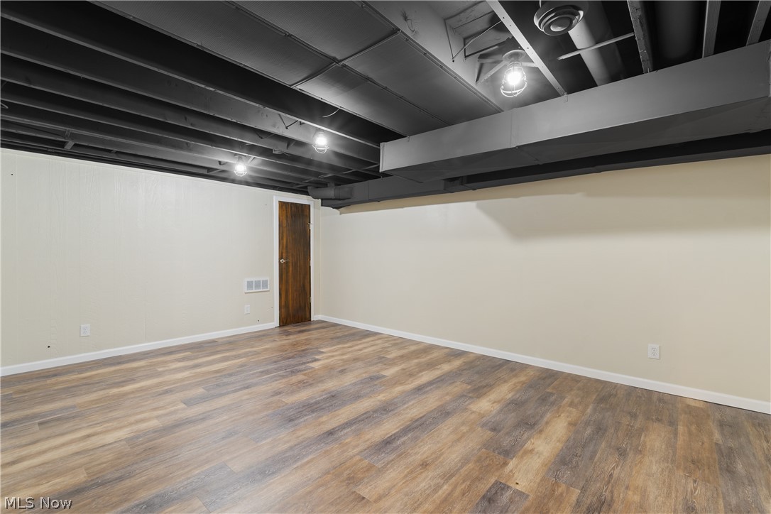 1075 Northeast River Road Lake Milton, OH 44429 - Photo 25 of 34 Spacious room featuring wood-finish flooring and neutral wall tones