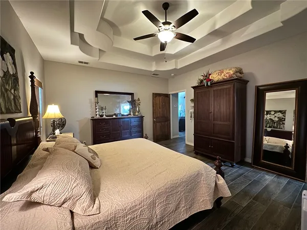 a bedroom with a bed and a large mirror with a flat tv screen