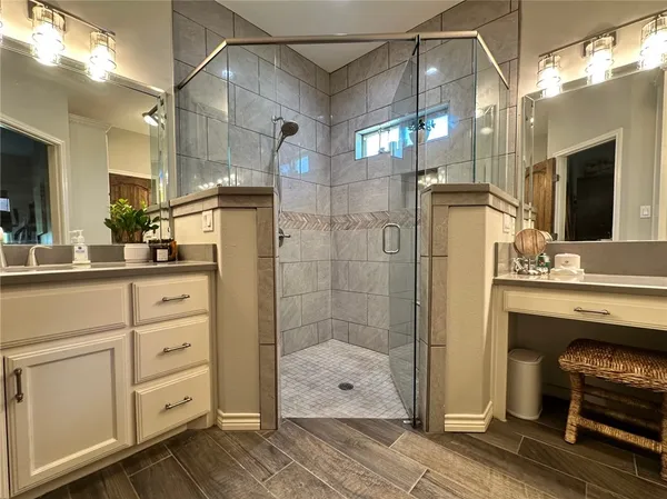a bathroom with a sink a mirror and shower