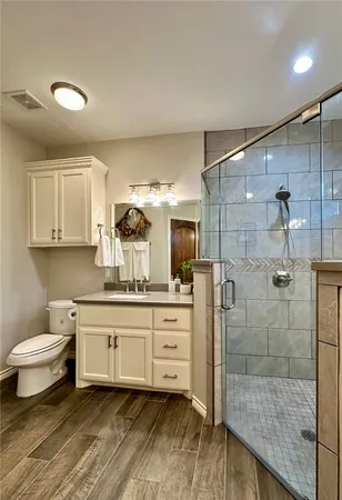 a bathroom with a double vanity sink toilet and shower