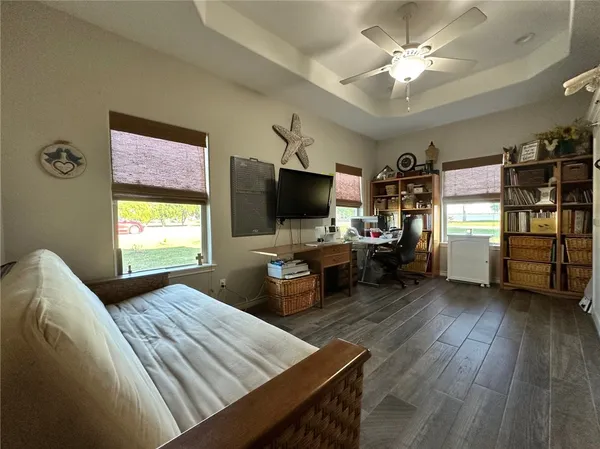 a bedroom with furniture and a flat screen tv