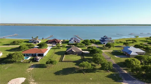 an aerial view of a houses with a lake view