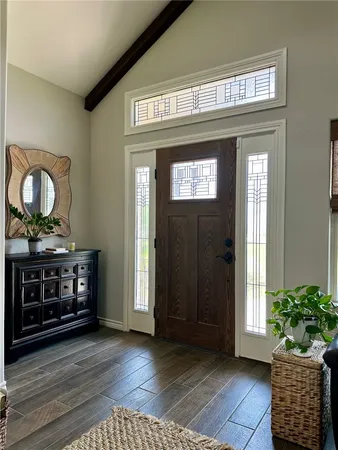a view of an entryway with wooden floor