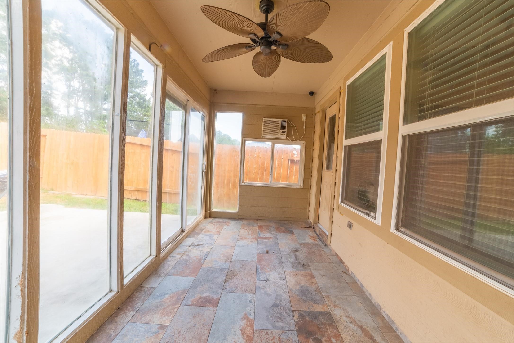 10510 Chestnut Path Way Tomball, TX 77375 - Photo 16 of 18 Bonus glassed in sunroom/patio with slate flooring and a ceiling fan plus AC window unit