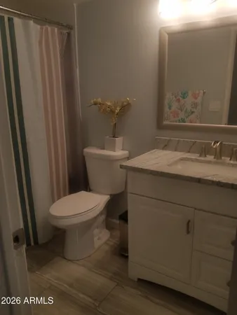 a white toilet sitting next to a bathroom sink