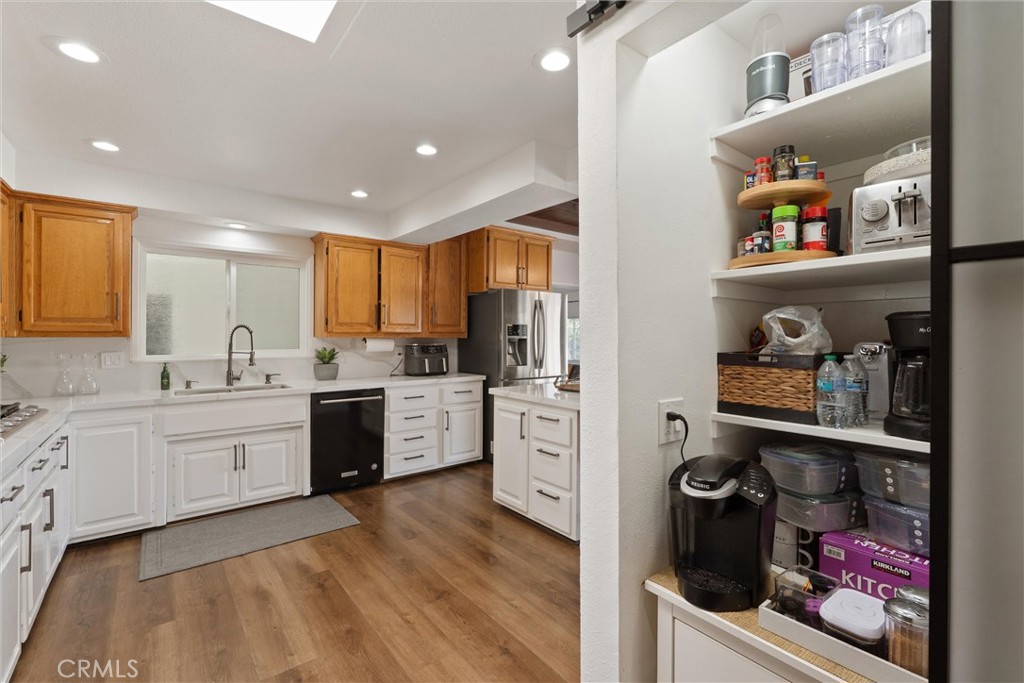 1675 West Mells Lane Anaheim, CA 92802 - Photo 26 of 46 a kitchen with refrigerator and cabinets