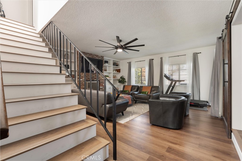 1675 West Mells Lane Anaheim, CA 92802 - Photo 31 of 46 a living room with furniture ceiling fan and a rug