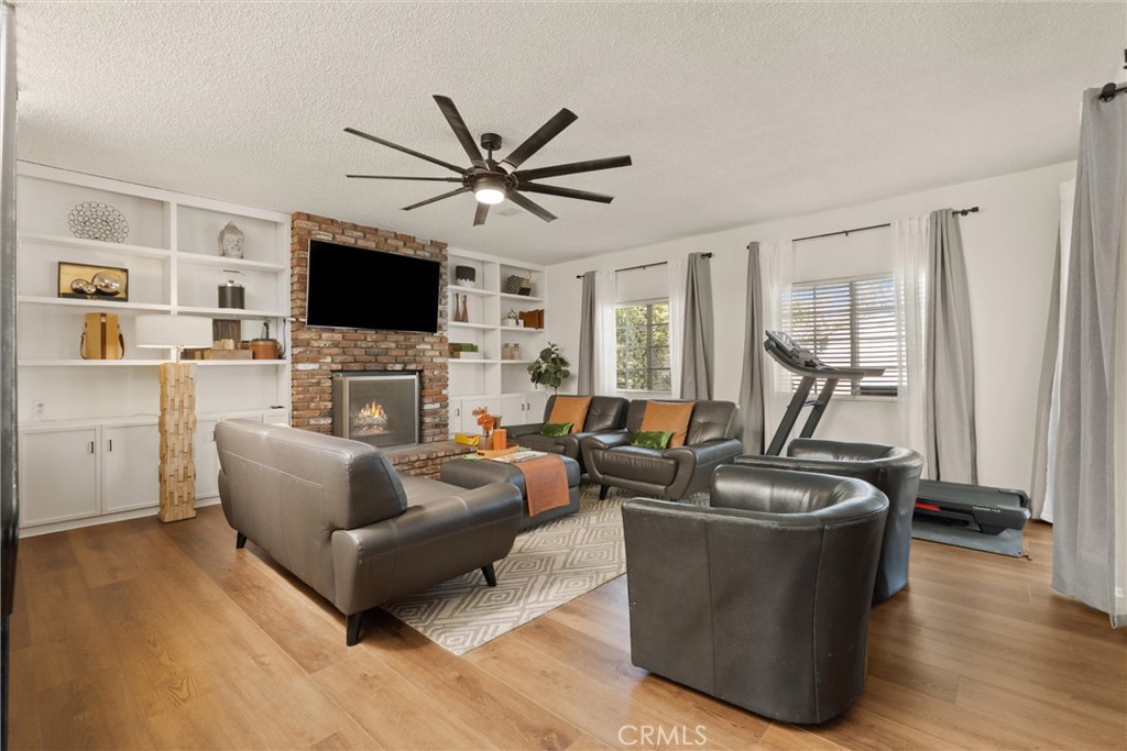 1675 West Mells Lane Anaheim, CA 92802 - Photo 32 of 46 a living room with furniture a flat screen tv and a large window