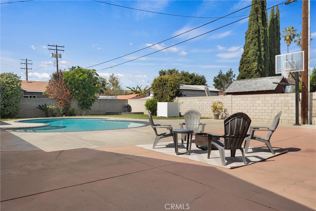 1675 West Mells Lane Anaheim, CA 92802 - Photo 37 of 46 a view of yard with seating space and trees in the background