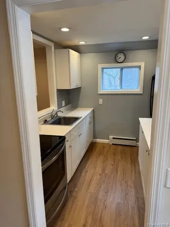 a kitchen with a stove and white cabinets