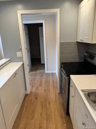 a kitchen with a sink a stove and cabinets