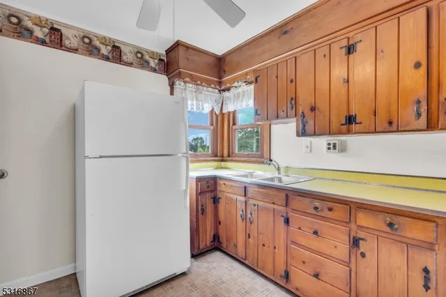 a kitchen with cabinets appliances and a sink