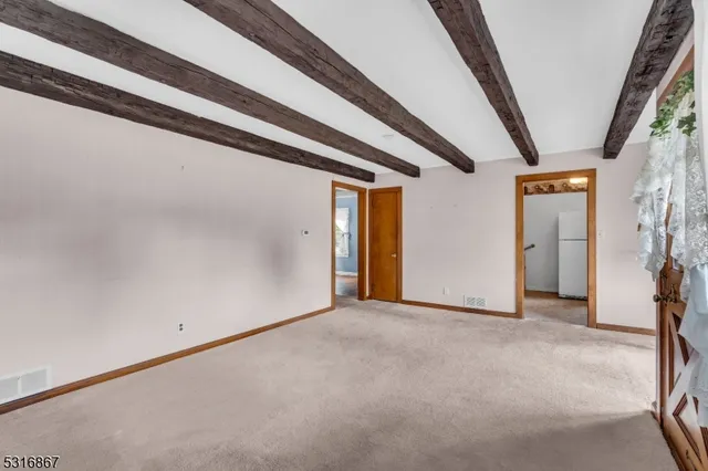 a view of a big room with fireplace and window