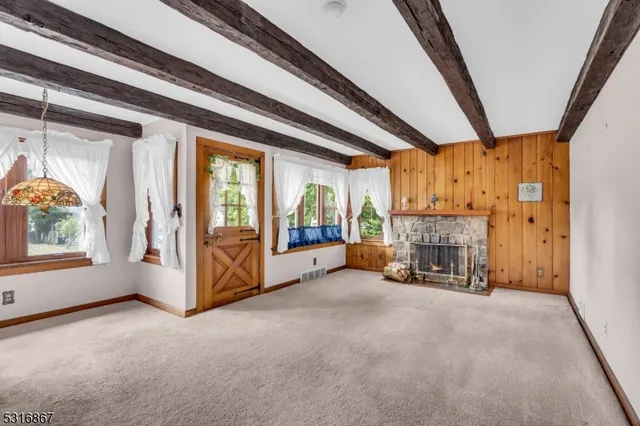 a view of a hallway with wooden floor and cabinet