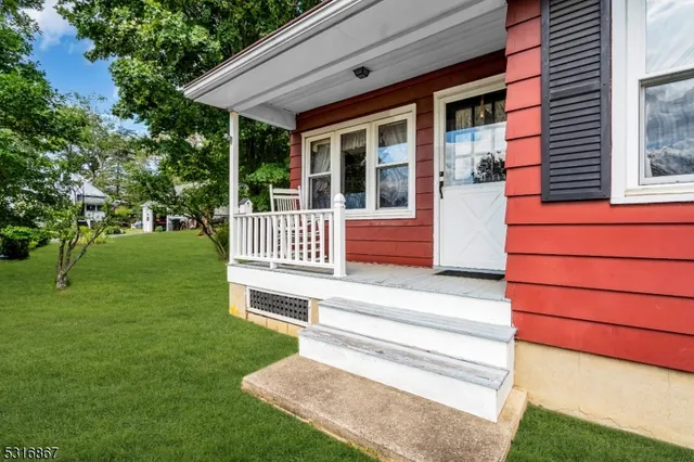 a view of backyard with deck and garden