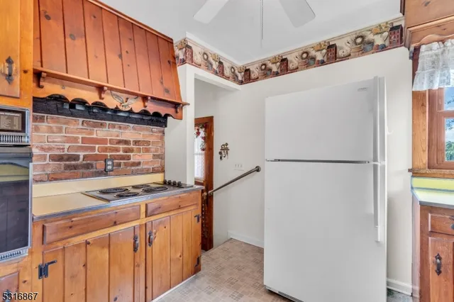 a kitchen with stainless steel appliances granite countertop a refrigerator and a stove