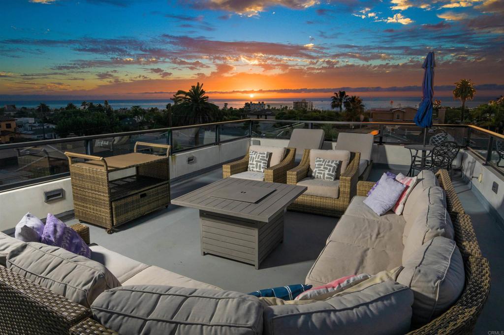 a view of a terrace with couches and sky view