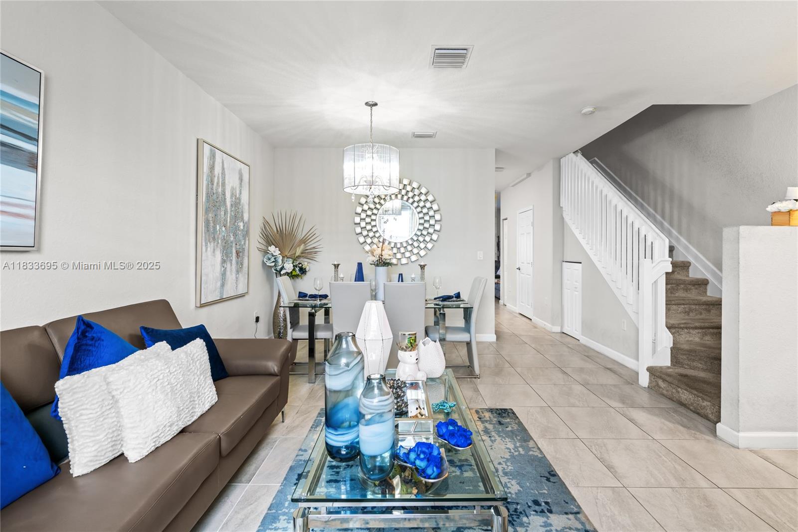 10468 West 33rd Lane Hialeah, FL 33018 - Photo 11 of 77 a living room with furniture and a chandelier