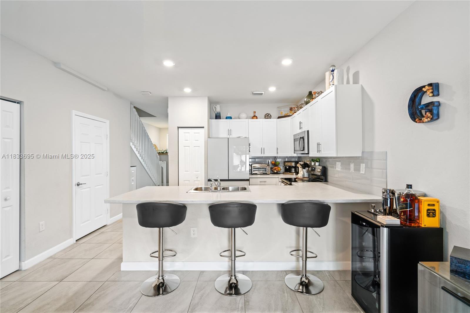 10468 West 33rd Lane Hialeah, FL 33018 - Photo 18 of 77 a kitchen with appliances cabinets and chair