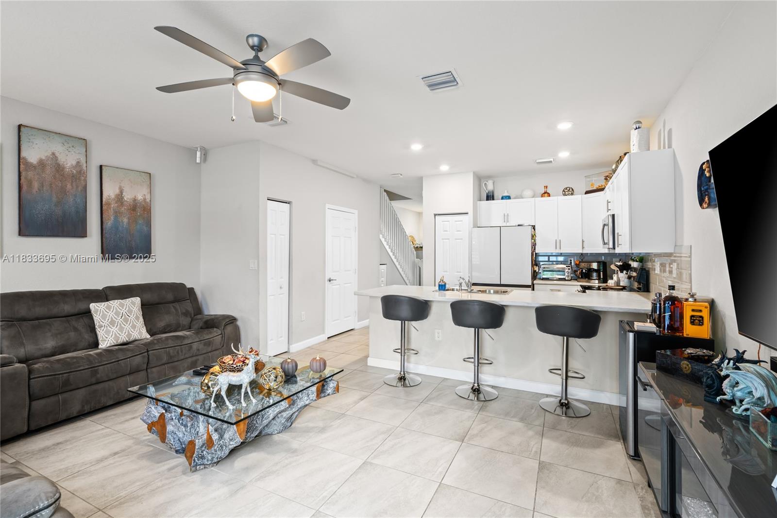 10468 West 33rd Lane Hialeah, FL 33018 - Photo 24 of 77 a living room with furniture and kitchen view