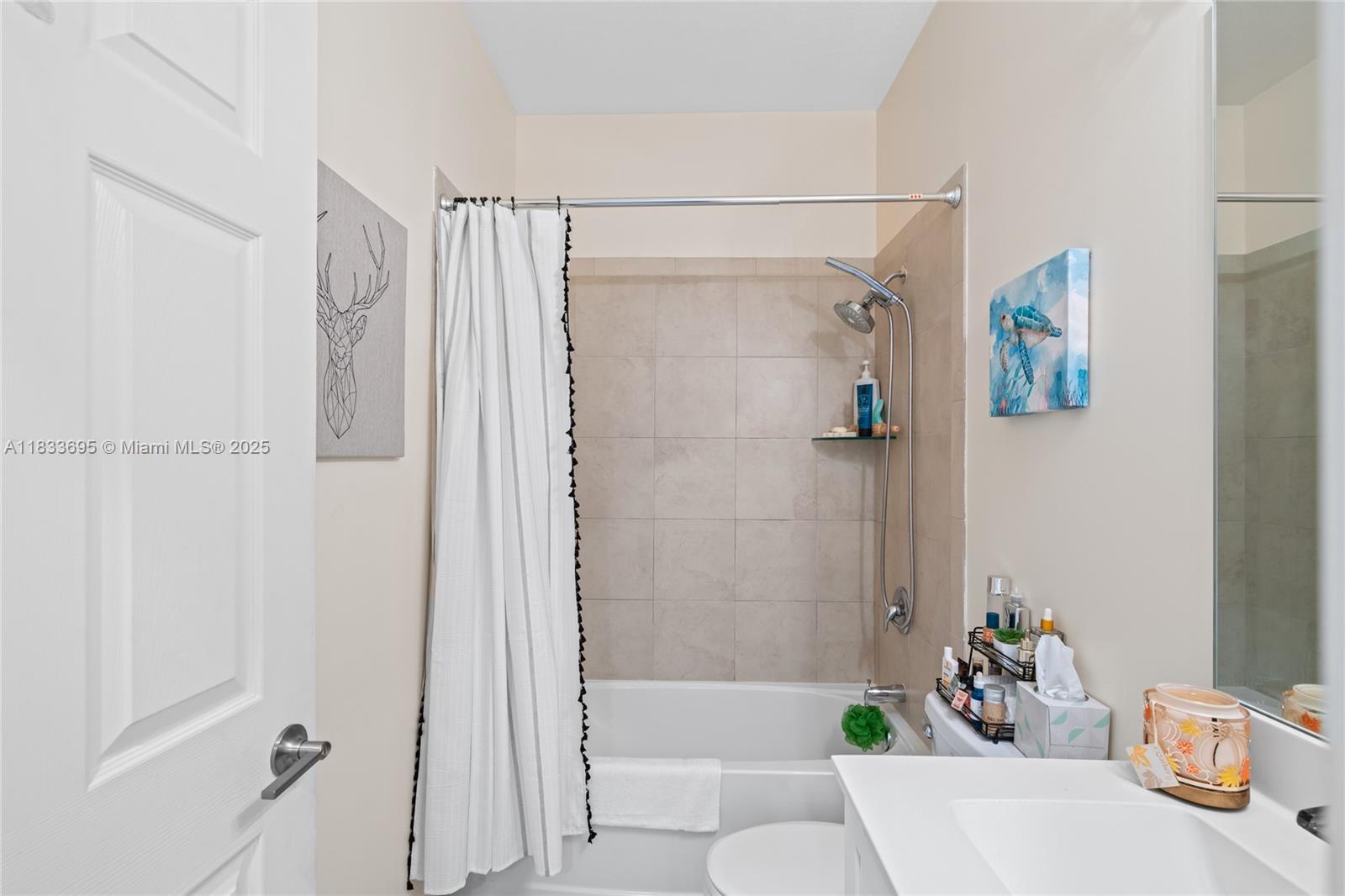 10468 West 33rd Lane Hialeah, FL 33018 - Photo 45 of 77 a bathroom with a bathtub and a shower