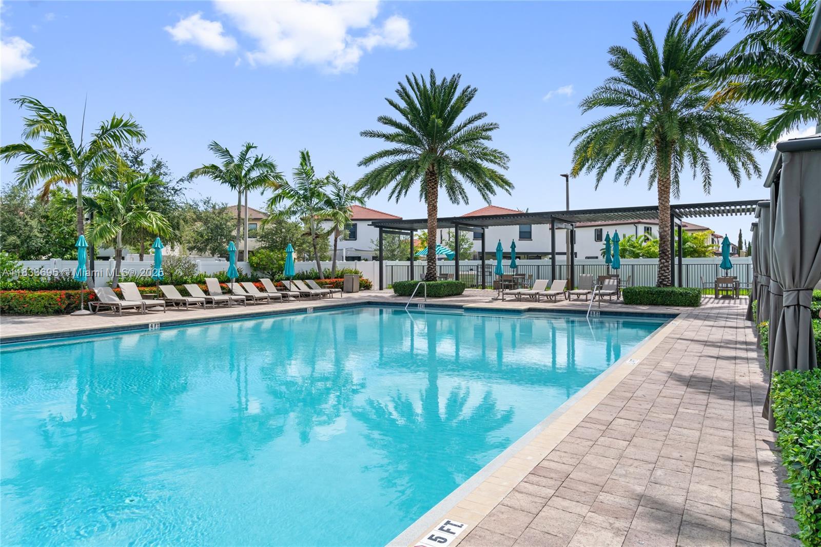 10468 West 33rd Lane Hialeah, FL 33018 - Photo 69 of 77 a view of swimming pool with a table and chairs