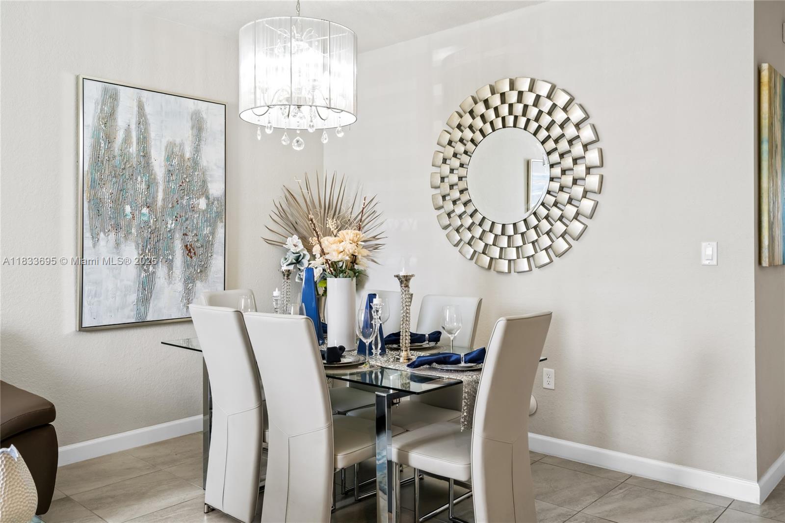 10468 West 33rd Lane Hialeah, FL 33018 - Photo 8 of 77 a view of a dining room with furniture and chandelier
