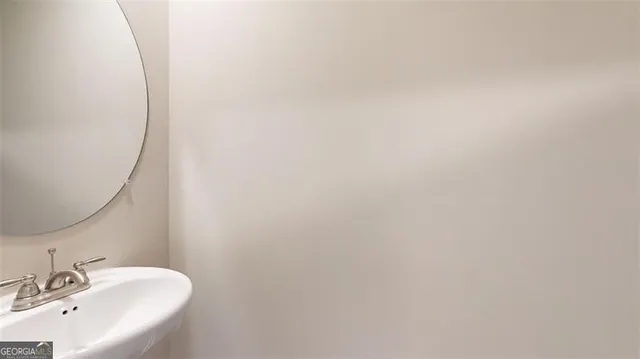 a bathroom with a sink and mirror