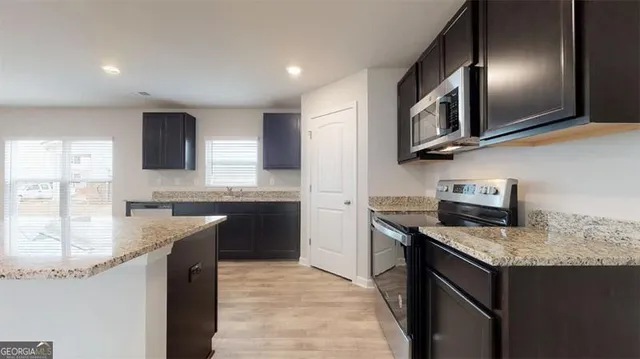 a kitchen with granite countertop stainless steel appliances and sink
