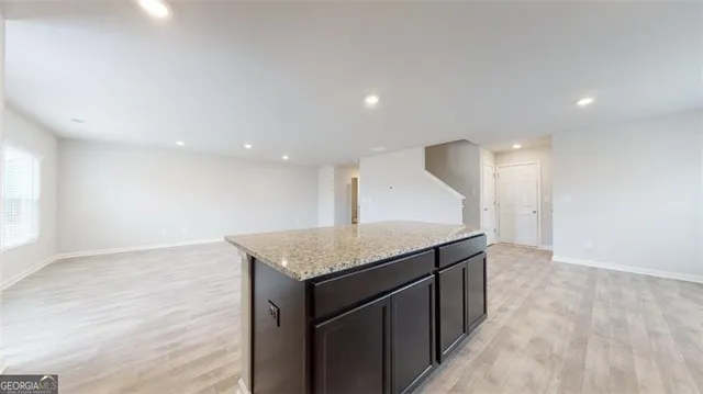 a kitchen with a sink vanity and a mirror