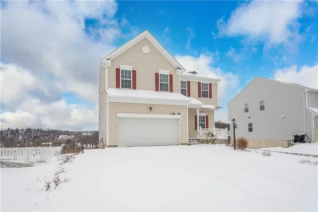 a view of a house with a snow in the yard
