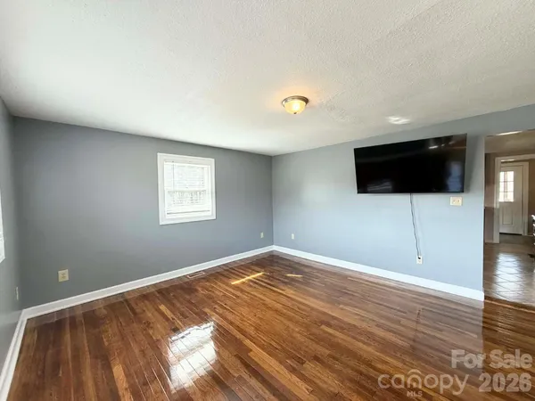 a view of a room with wooden floor and windows