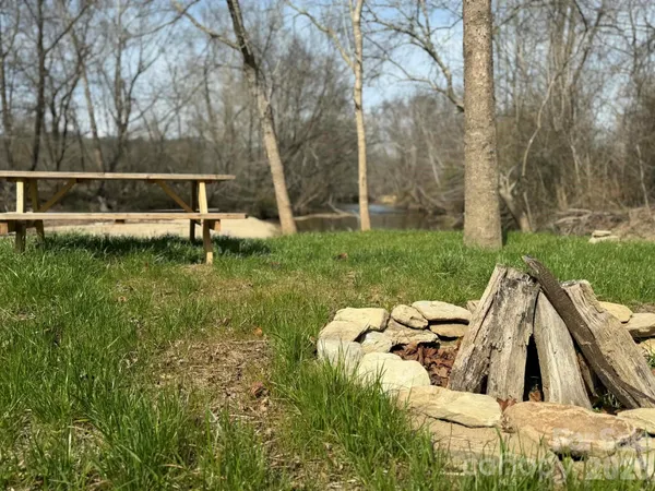 a view of backyard with large trees and a small yard