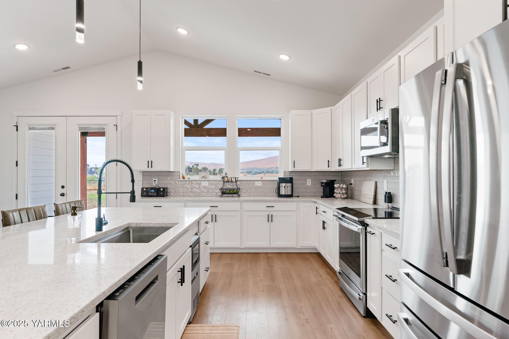 12907 Douglas Road Yakima, WA 98908 - Photo 12 of 44 a kitchen with white cabinets stainless steel appliances and a sink