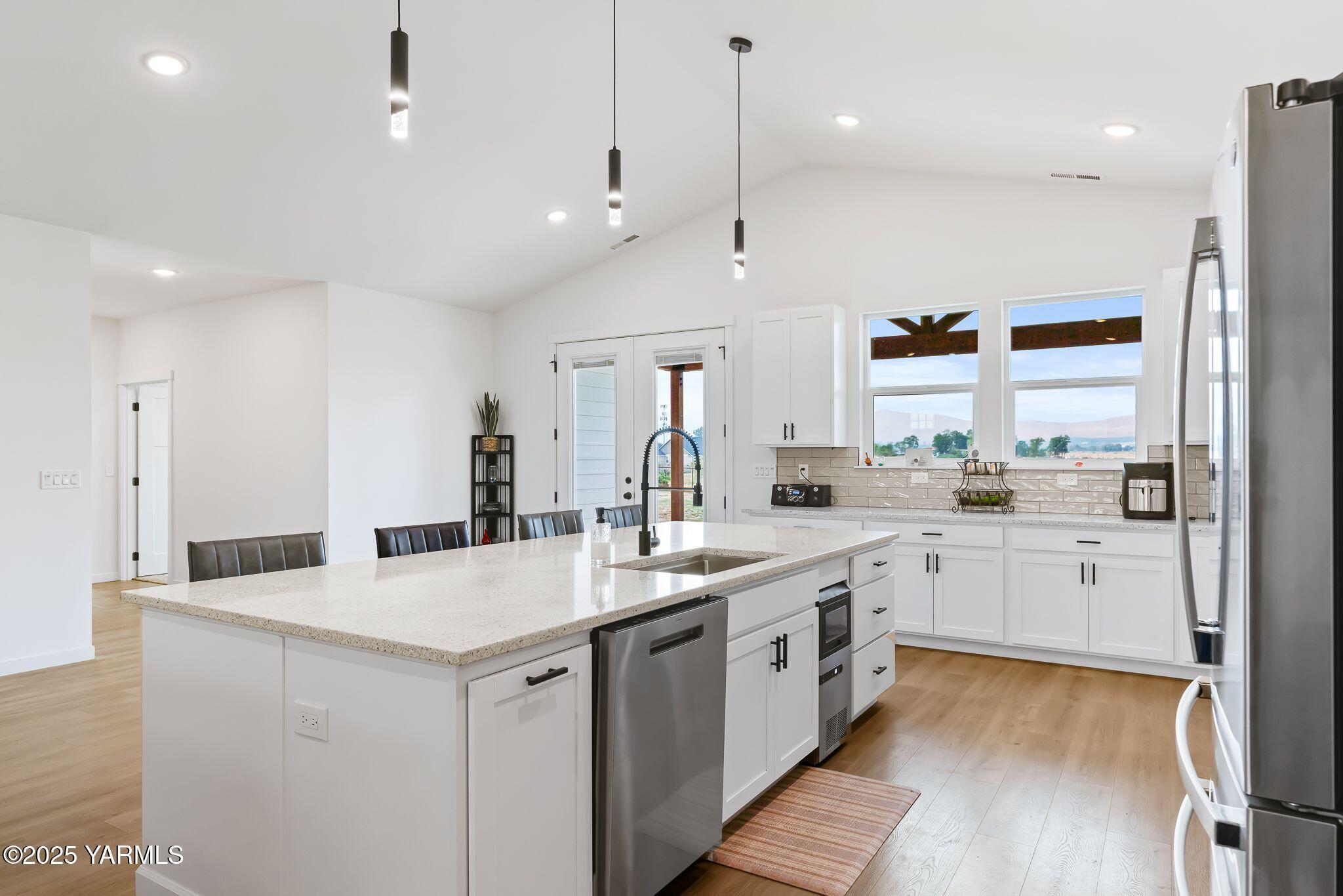 12907 Douglas Road Yakima, WA 98908 - Photo 13 of 44 a large kitchen with kitchen island a sink a center island a stove and a window