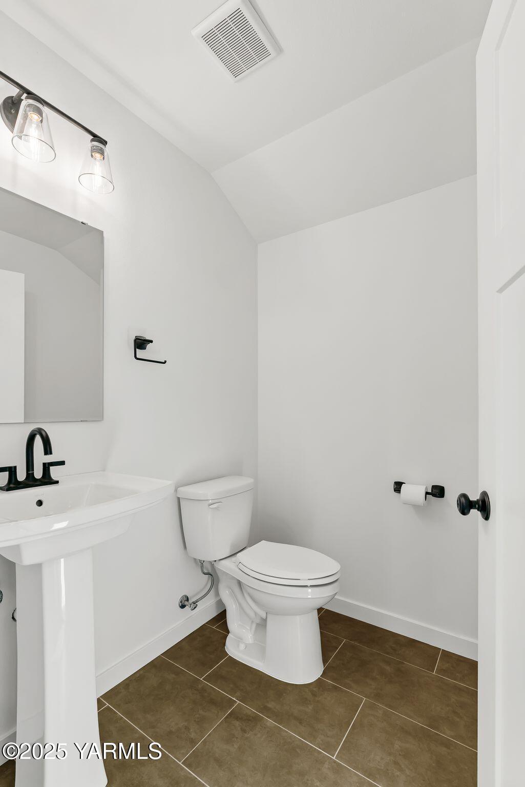 12907 Douglas Road Yakima, WA 98908 - Photo 27 of 44 a white toilet sitting next to a bathroom sink