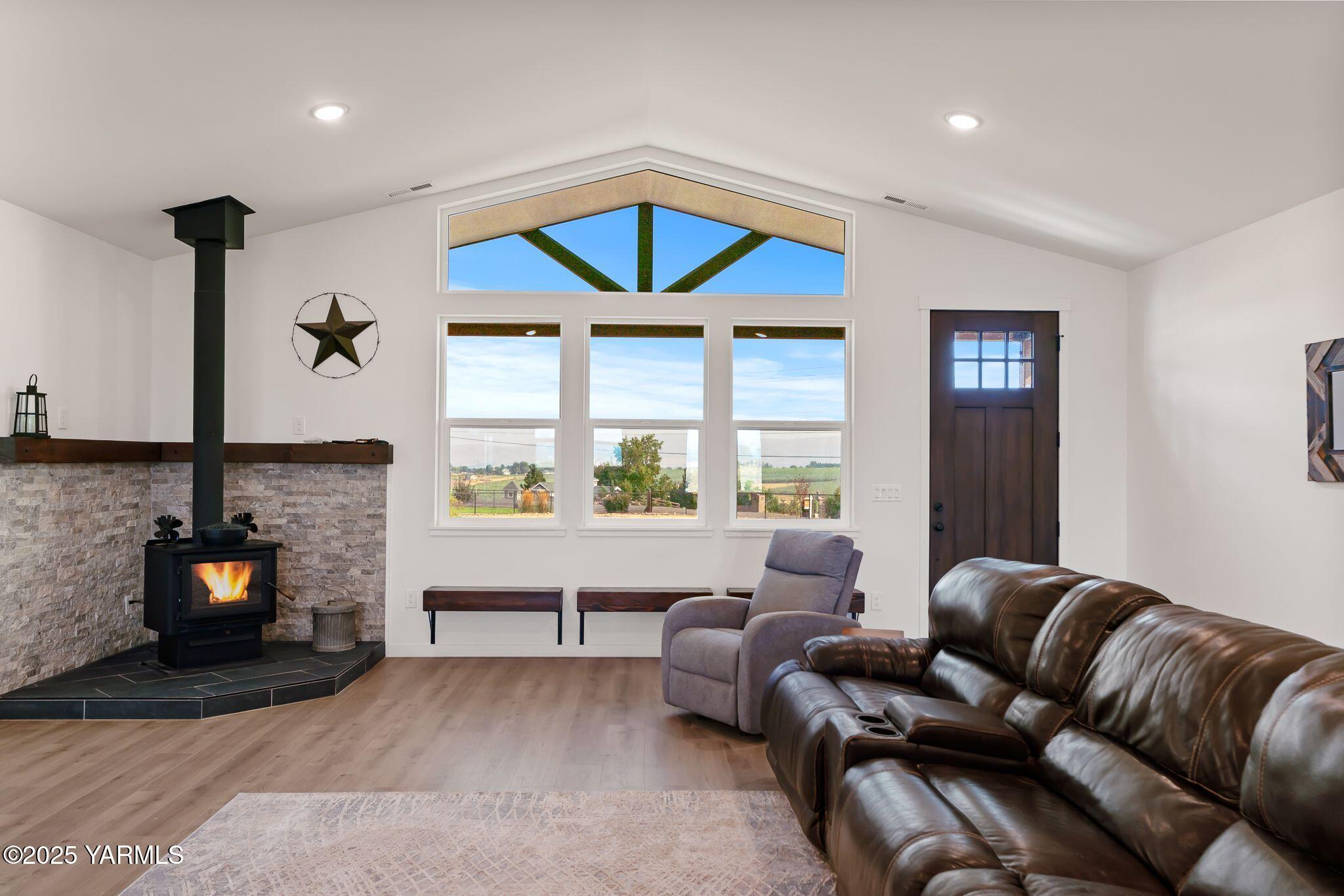 12907 Douglas Road Yakima, WA 98908 - Photo 4 of 44 a living room with furniture a fireplace and a flat screen tv