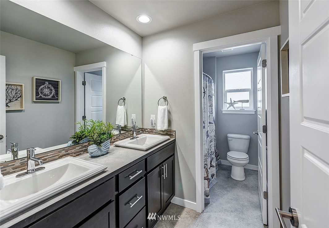 19310 37th Drive Southeast Bothell, WA 98012 - Photo 12 of 22 a bathroom with a double vanity sink toilet and shower