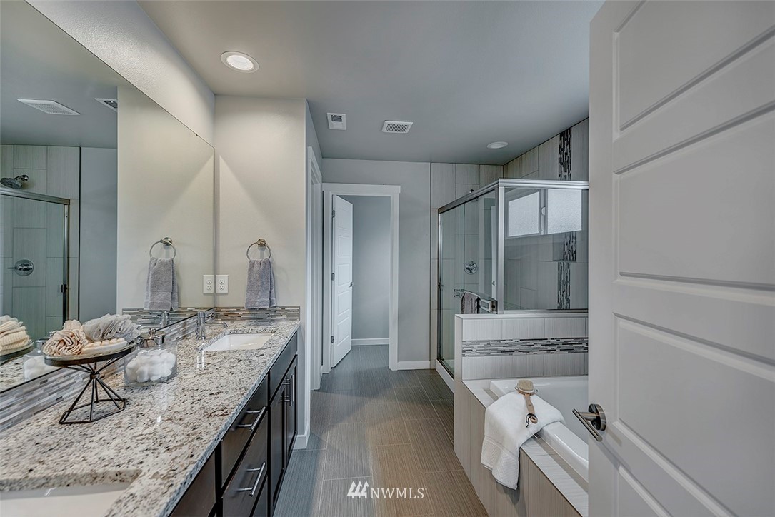 19310 37th Drive Southeast Bothell, WA 98012 - Photo 17 of 22 a bathroom with a granite countertop sink and a mirror