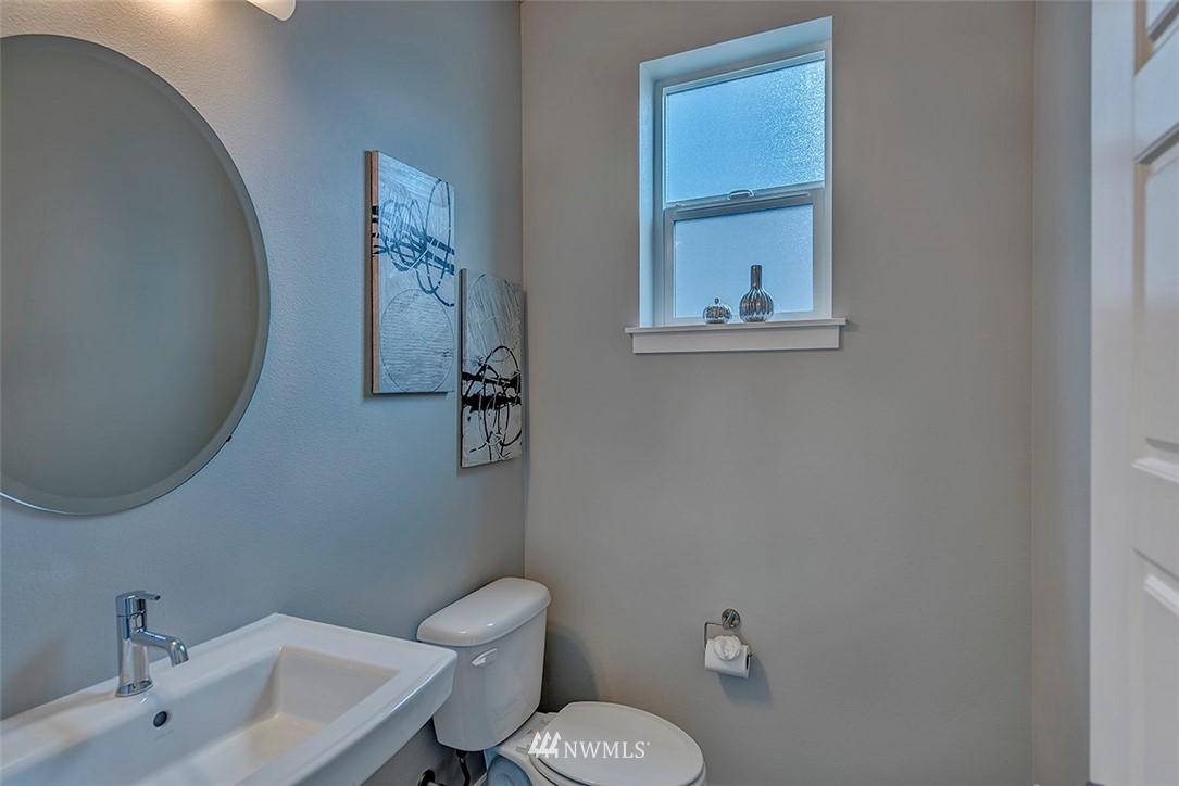 19310 37th Drive Southeast Bothell, WA 98012 - Photo 18 of 22 a bathroom with a toilet sink and mirror