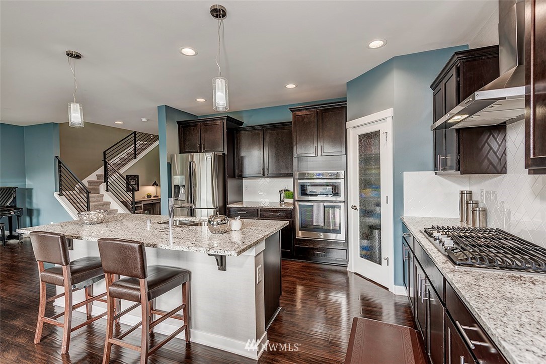 19310 37th Drive Southeast Bothell, WA 98012 - Photo 9 of 22 a kitchen with refrigerator a stove and chairs
