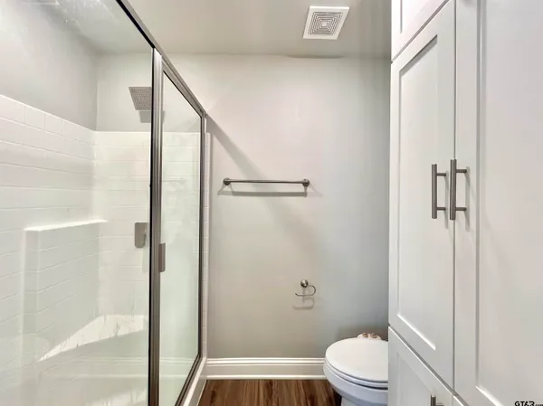 a bathroom with a toilet and a shower