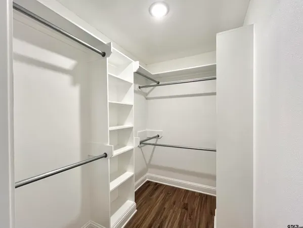 a view of walk in closet with empty racks