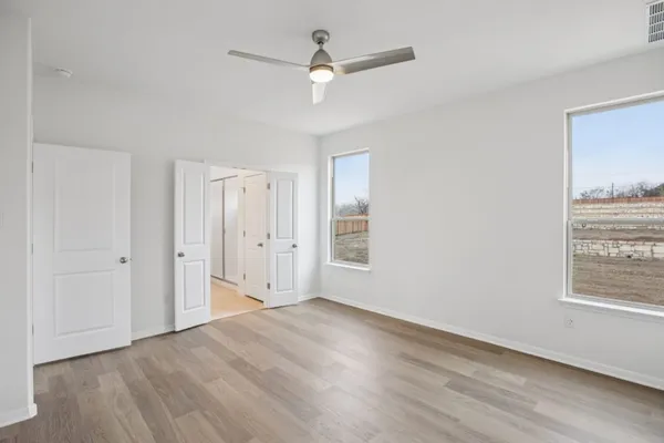 a bed sitting in a room next to a window