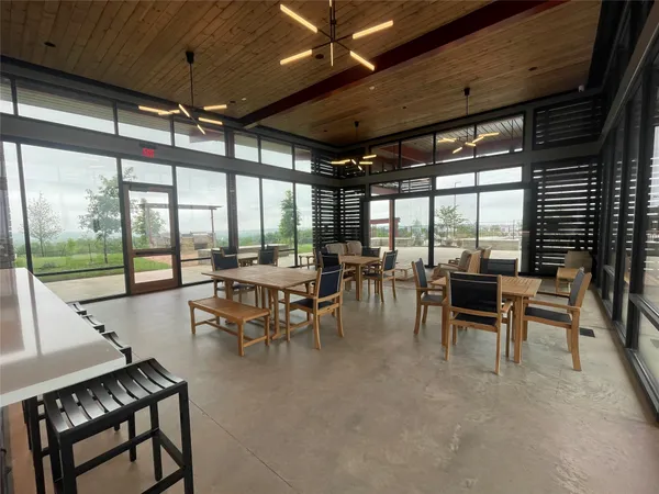 a kitchen with stainless steel appliances granite countertop a refrigerator a stove and white cabinets with wooden floor