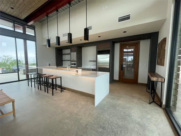 a kitchen with kitchen island granite countertop a sink stainless steel appliances and cabinets
