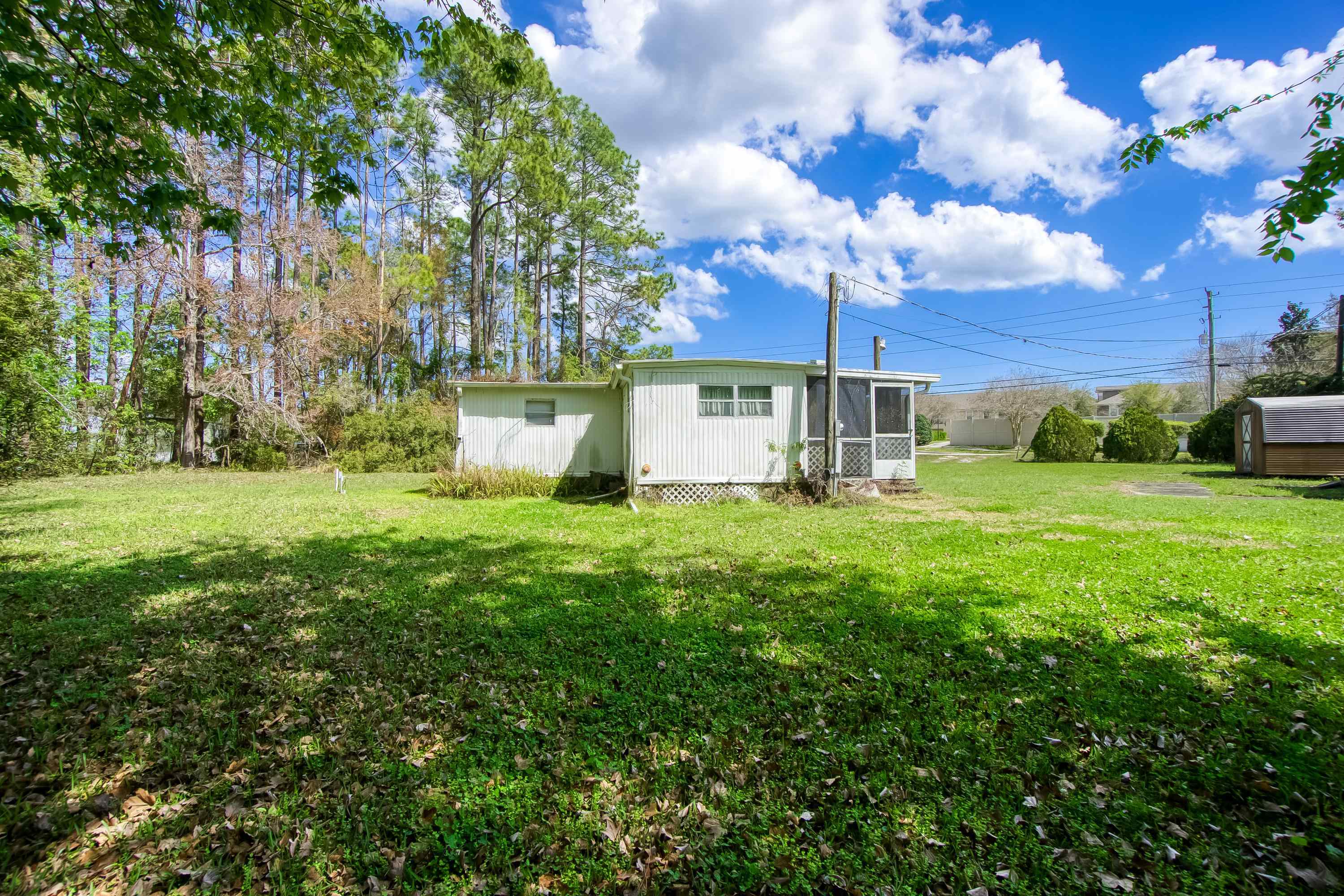 2785 Stratton Boulevard St. Augustine, FL 32084 - Photo 13 of 25 View of grassy yard featuring a sunroom