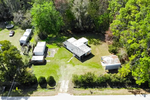 an aerial view of a house with yard swimming pool and outdoor seating