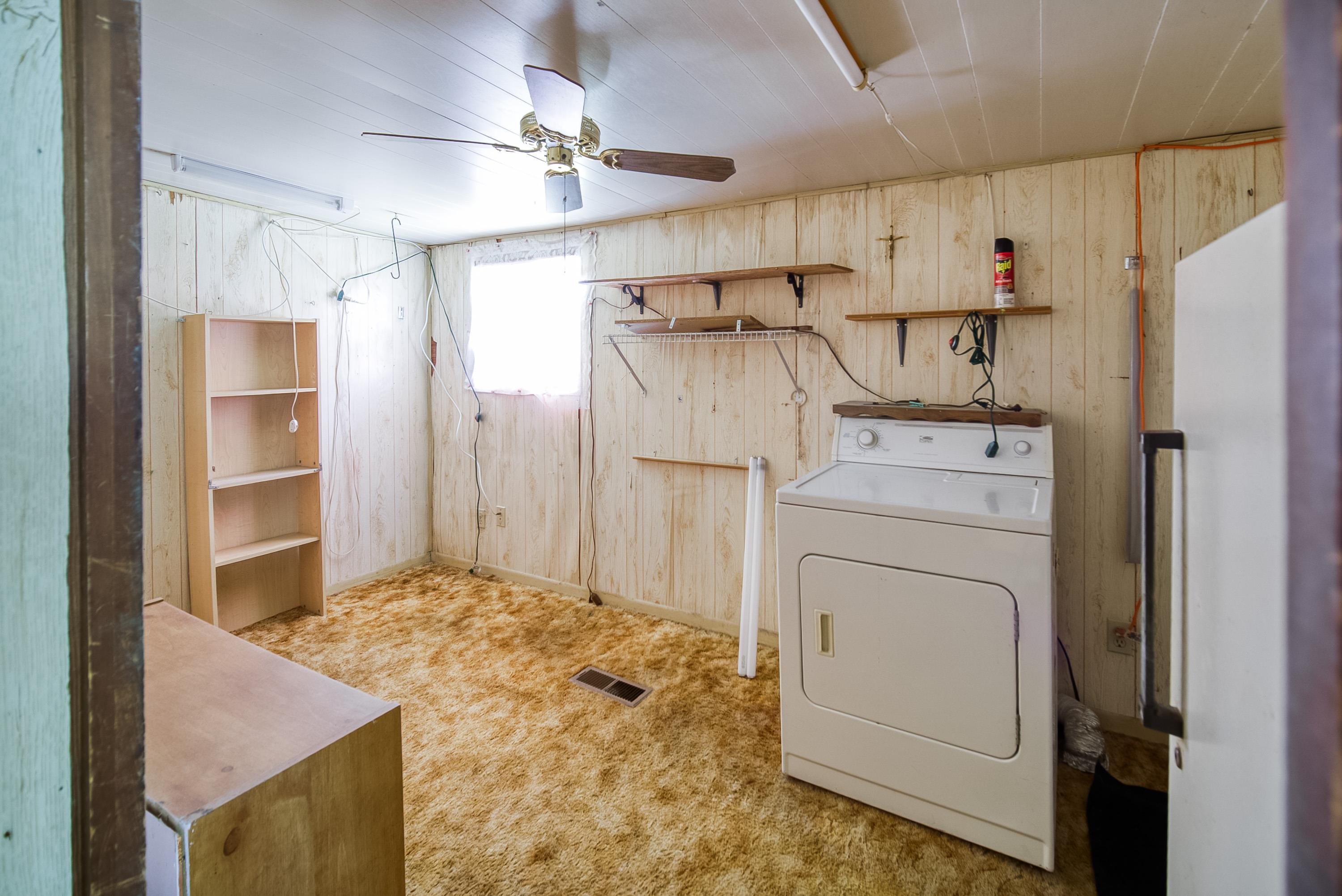 2785 Stratton Boulevard St. Augustine, FL 32084 - Photo 24 of 25 Laundry area with washer / dryer, wooden walls, light carpet, and ceiling fan